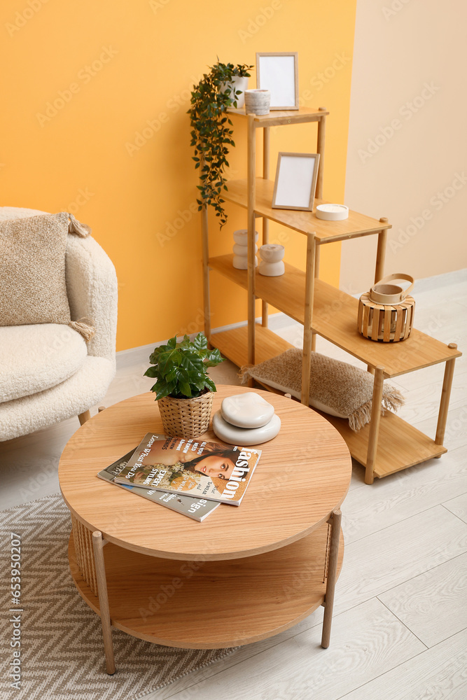 Modern living room interior with stylish wooden coffee table and shelving unit