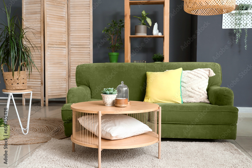 Interior of modern living room with plants, sofa and coffee table