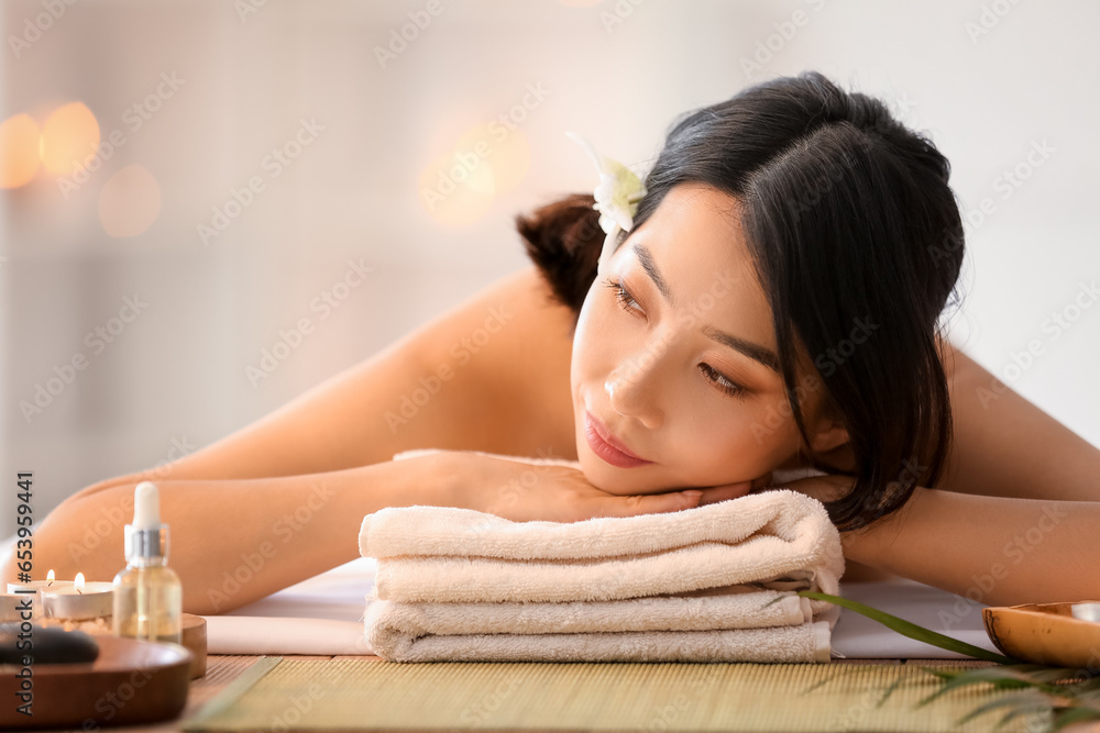 Pretty young Asian woman in spa salon