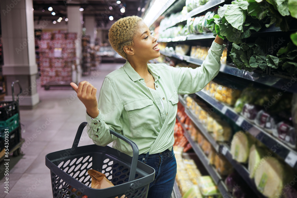 Woman, grocery shopping and vegetables choice, discount and sale or wholesale promotion of healthy food in basket. Happy African customer with spinach in retail, convenience store or supermarket deal