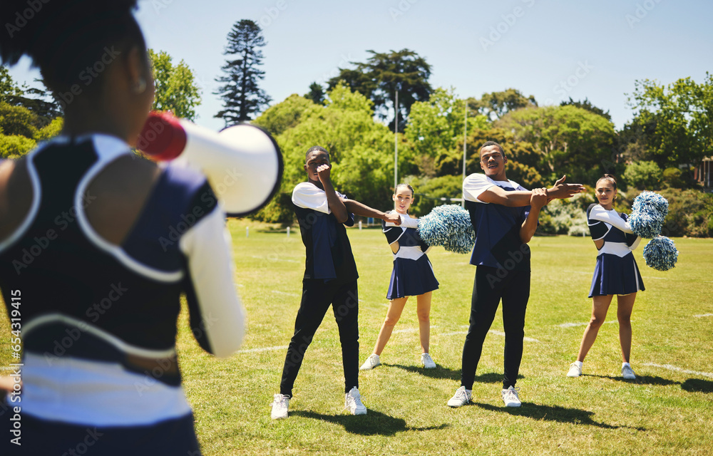 Cheerleading team, coach and megaphone for practice, stretching and sports field for dancing, cheering and support. Training, warm up and outdoor for exercise together, competition and energy