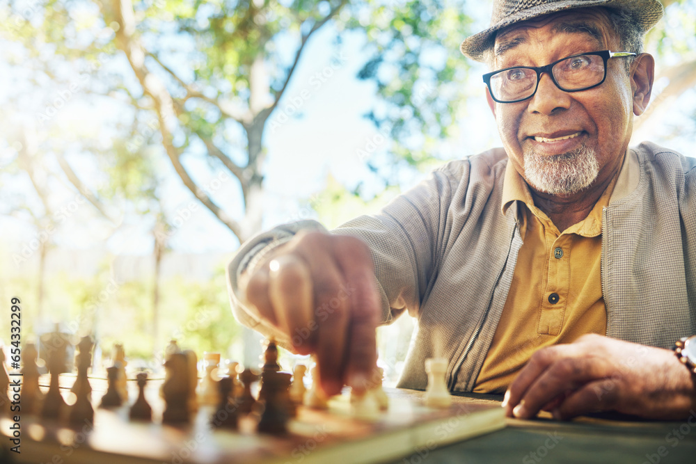 Elderly man in park, hand and chess game strategy, competition or challenge, retirement and moving piece. Closeup, planning and contest outdoor, concentration on boardgame and excited in nature