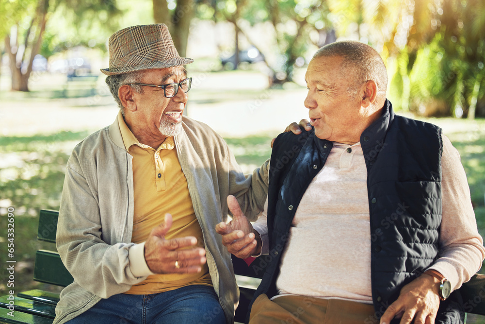 Talking, senior and friends in a park for bonding, communication or together in retirement. Happy, elderly and men speaking with care, smile and enjoying conversation in nature interaction to relax