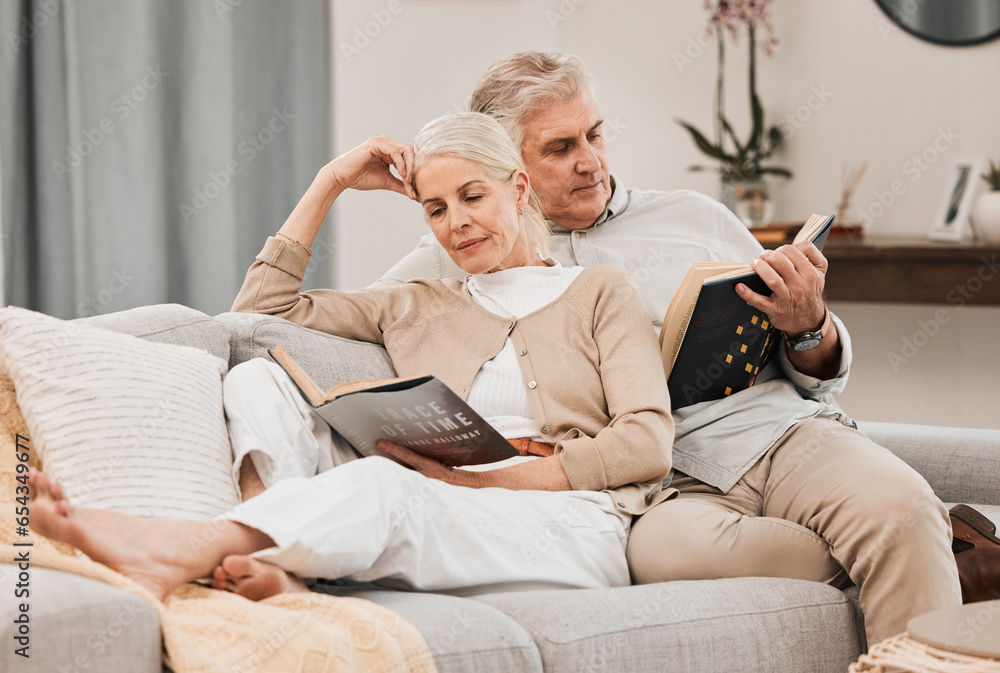 Old people on couch, reading book and relax together at home, retirement and wellness with love and comfort. Trust, care and support in marriage, share hobby with partner for knowledge and story