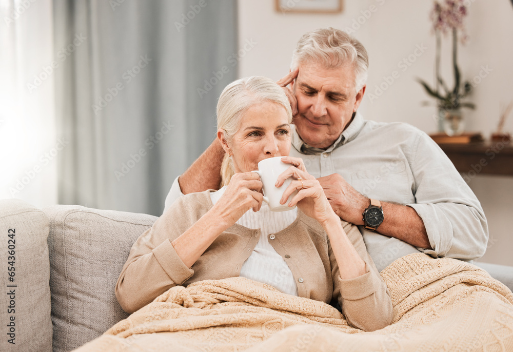 Old couple, hug and relax on couch with coffee, love and support, bonding while at home with trust and comfort. People have tea together, marriage or partner with retirement, calm and peace of mind