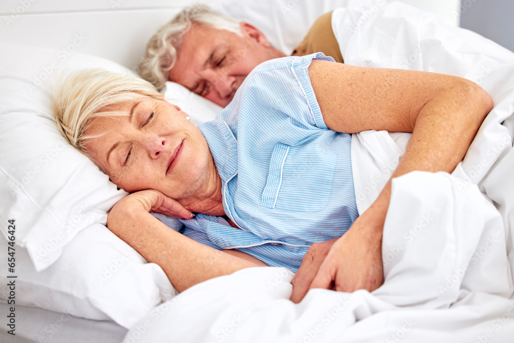 Sleeping, bedroom and senior couple with love, relax and retirement on a weekend break, resting and calm. Peace, old woman or elderly man in a bed, home or morning with care, marriage or relationship