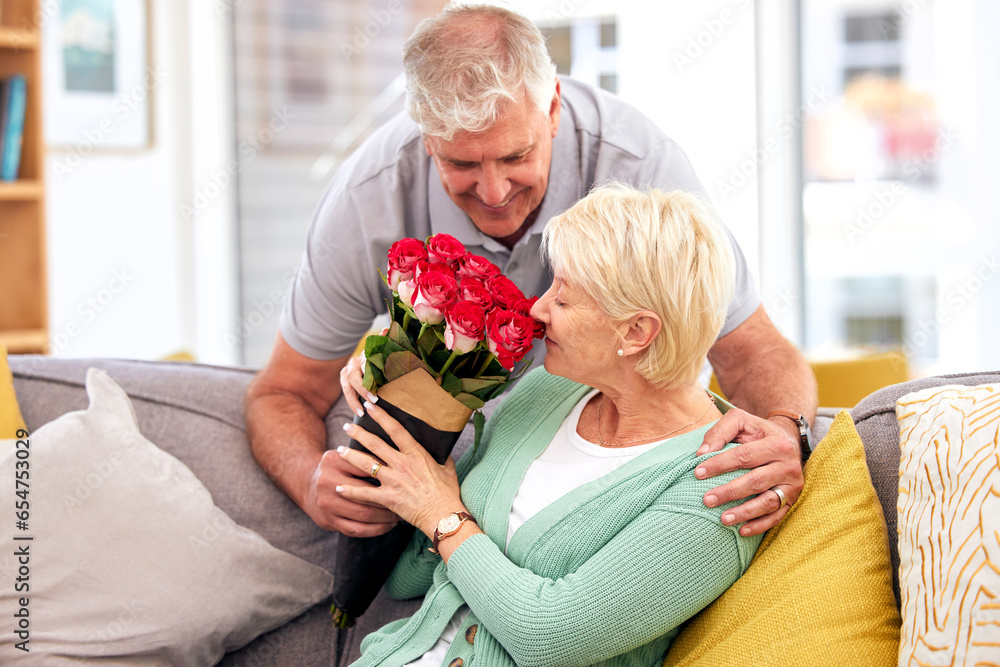 Love, hug or senior couple with flowers or gift in celebration of a happy marriage or valentines day. Present, mature or romantic man giving roses to a woman in retirement in house living room couch