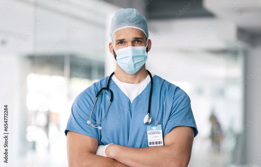 Portrait of man, surgeon in hospital with mask and ppe, healthcare worker with confidence and medicine. Health expert, medical professional and face of doctor in clinic with arms crossed in safety.