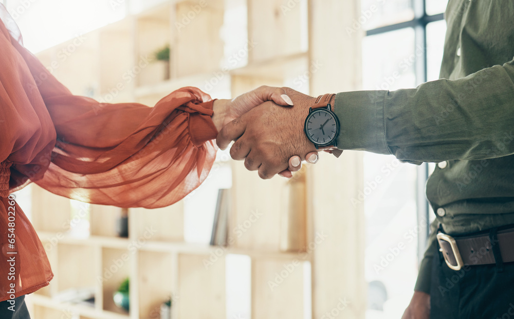 Creative people, handshake and partnership in meeting, b2b deal or teamwork together at office. Closeup of man and woman shaking hands for startup, introduction or thank you in agreement at workplace