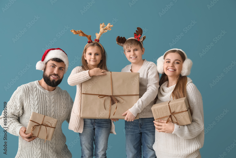 Happy family with Christmas gifts on blue background