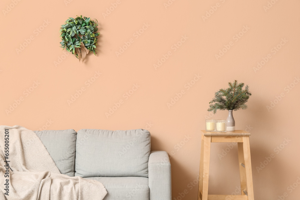 Interior of living room with Christmas mistletoe wreath and sofa