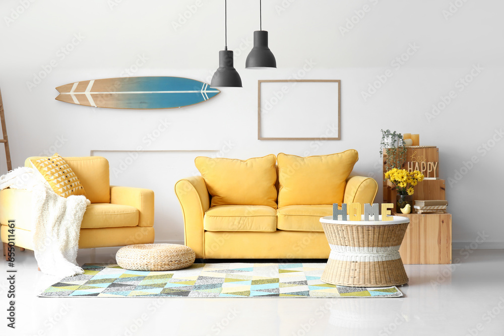 Interior of living room with yellow armchair and sofa