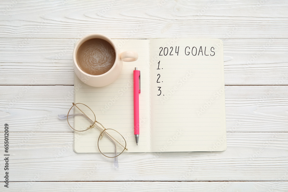 Notebook with empty to do list, eyeglasses and cup of coffee on white wooden background. New year goals