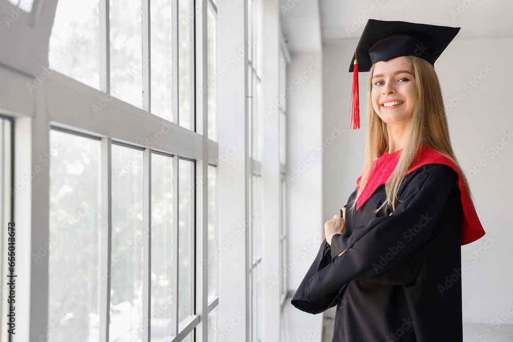 Female graduate student near window in room