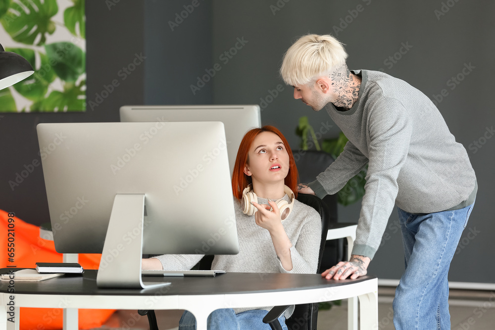 Young programmers working in office