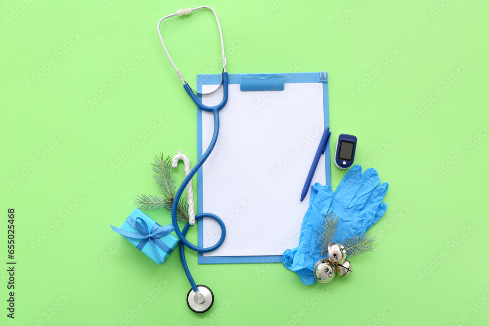 Medical supplies with Christmas decor on green background