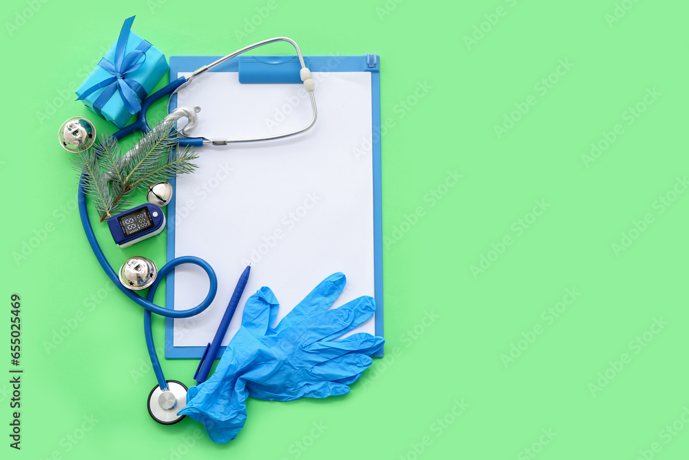 Medical supplies with Christmas decor on green background