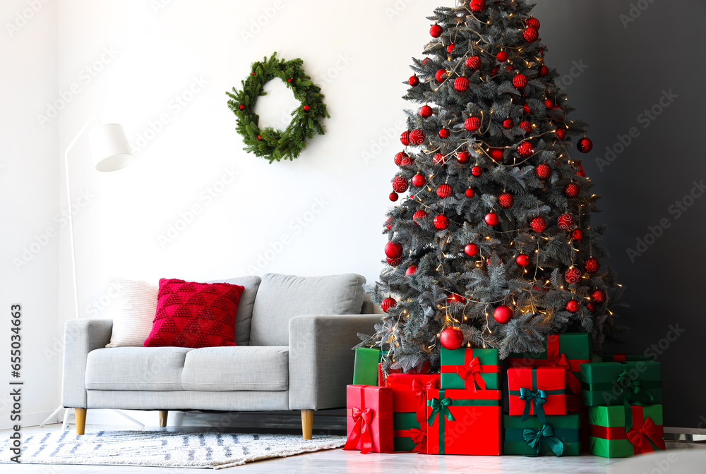 Interior of festive living room with gift boxes under Christmas tree