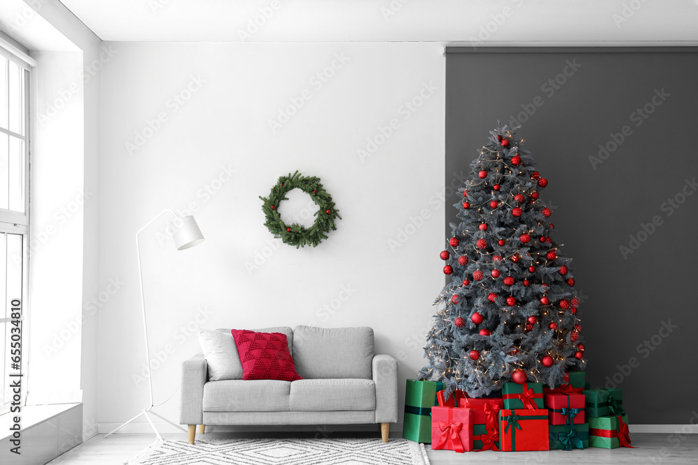 Interior of festive living room with gift boxes under Christmas tree