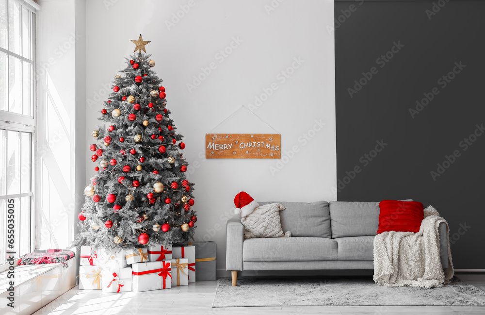 Interior of festive living room with gift boxes under Christmas tree