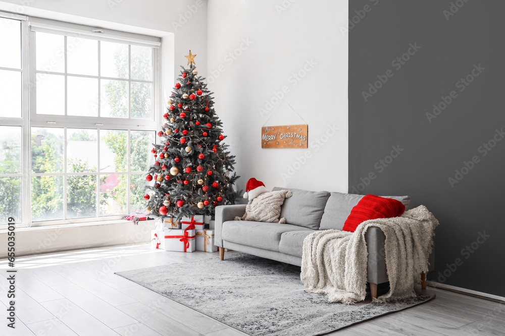 Interior of festive living room with gift boxes under Christmas tree