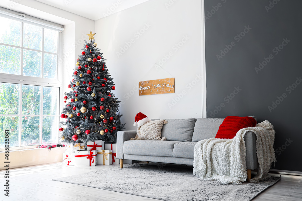 Interior of festive living room with gift boxes under Christmas tree