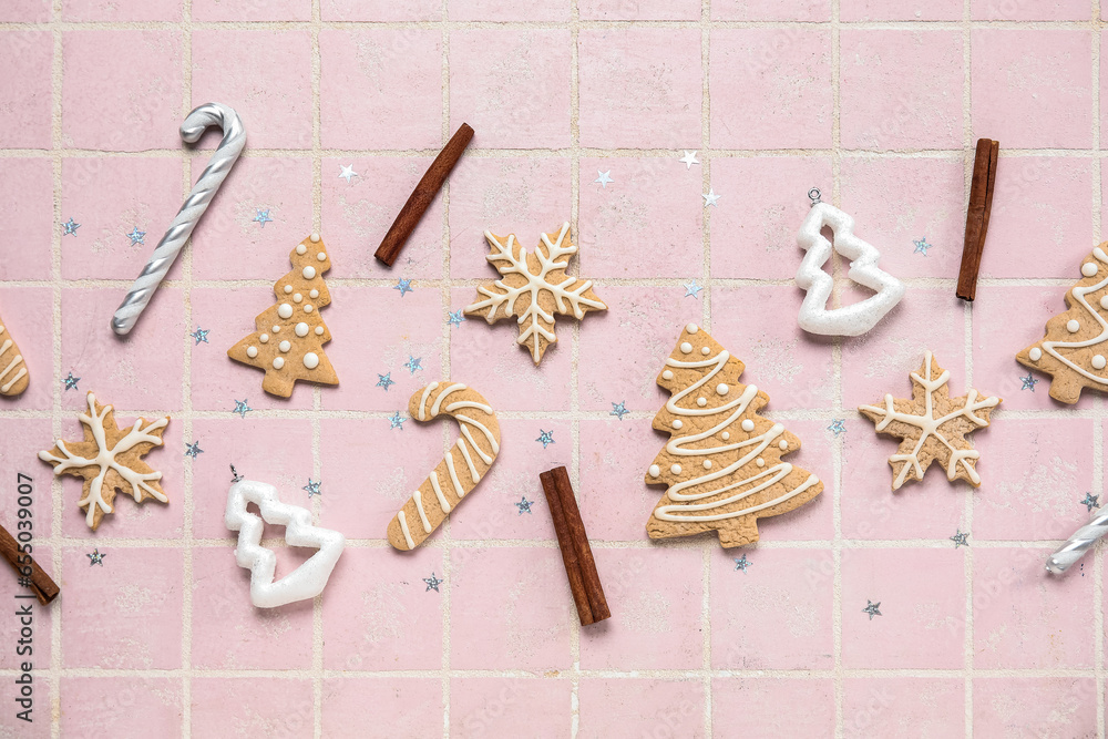 Composition with different Christmas cookies, decorations and cinnamon sticks on color tile background