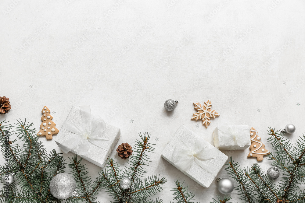 Christmas tree branches with balls and gift boxes on white background