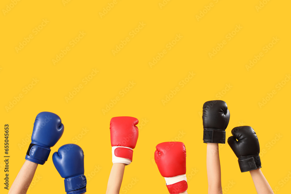 Female hands boxing gloves on orange background