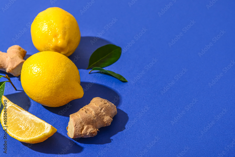 Fresh lemons and ginger roots on blue background