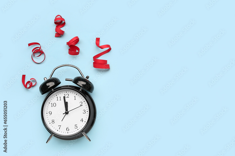 Composition with alarm clock and serpentine on color background