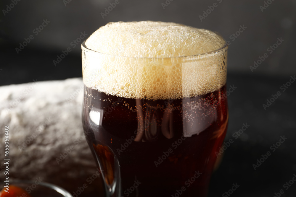 Glass of tasty kvass on black background