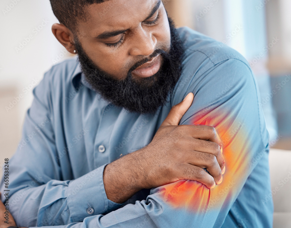 Black man, arm pain and remote work with injury, muscle problem and red inflammation at home. African male person, freelancer shoulder and joint damage with heart attack warning and stress in house