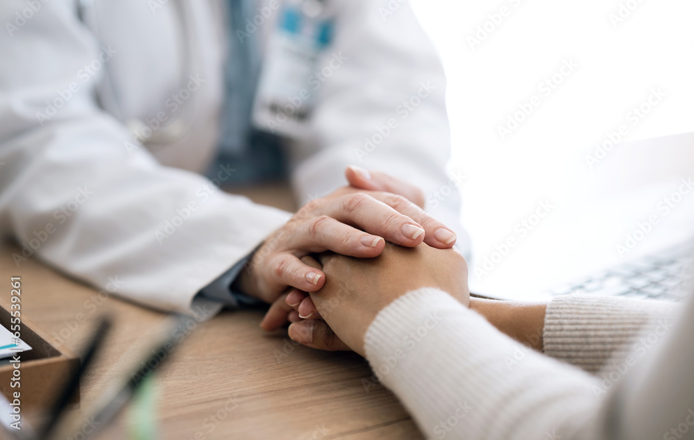 Hospital, holding hands and doctor with patient for care, comfort and empathy for diagnosis news. Healthcare consulting, clinic and health worker with person for support, wellness and medical results