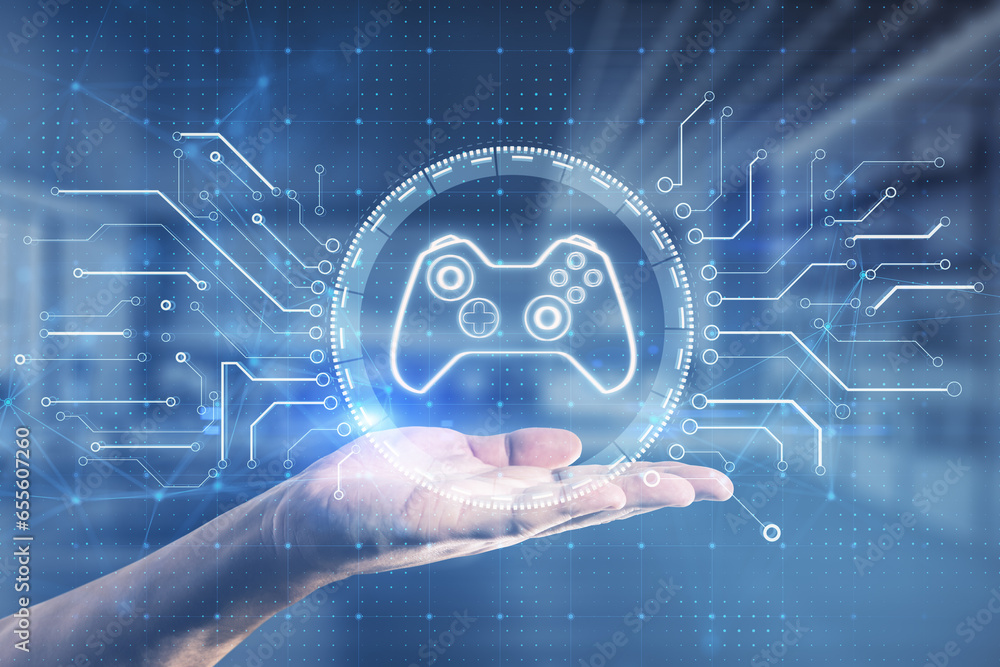 Close up of businessman hand holding creative joystick or gamepad hologram on blurry office interior background. Esport, gaming and fun concept. Double exposure.