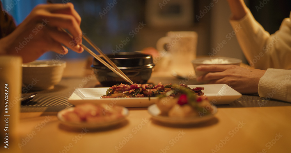 Close Up Portrait of a South Korean Young Couple Eating Food Together in the Kitchen. Cute Man and Woman are Happy with Their Lifestyle, Enjoying Traditional Korean Dinner with Meat and Rice