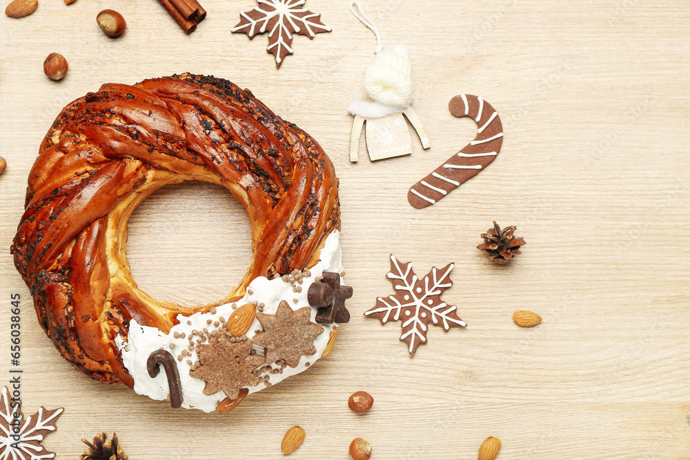 Tasty Christmas pastry wreath and cookies on wooden background