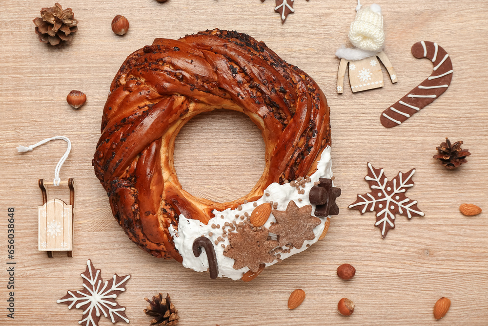 Tasty Christmas pastry wreath and cookies on wooden background