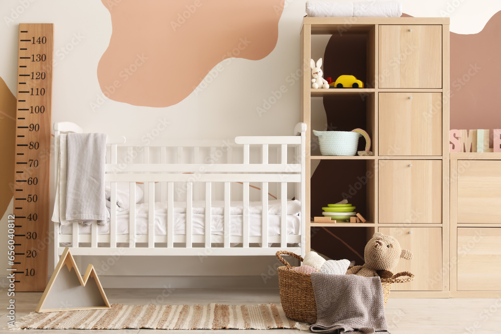 Interior of childrens bedroom with bed and shelving unit