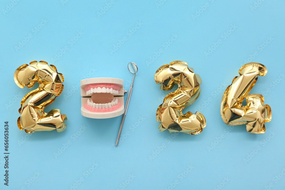 Jaw model with dental tool and figure 2024 on blue background