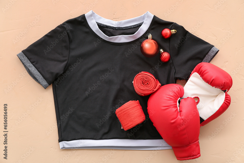 Boxers equipment with Christmas balls on beige background