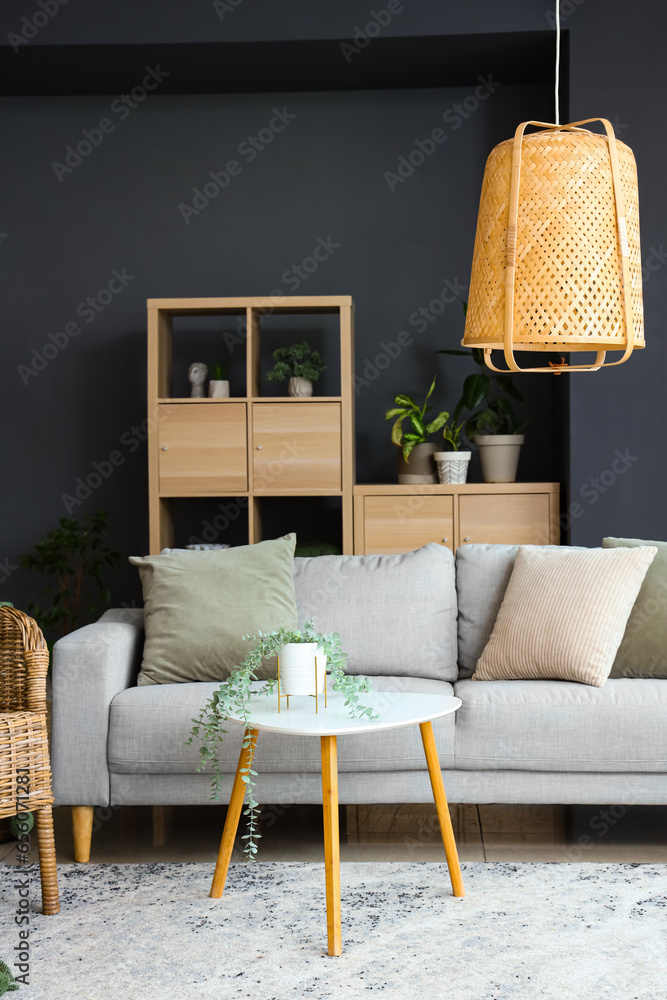 Interior of modern living room with plants, sofa and coffee table