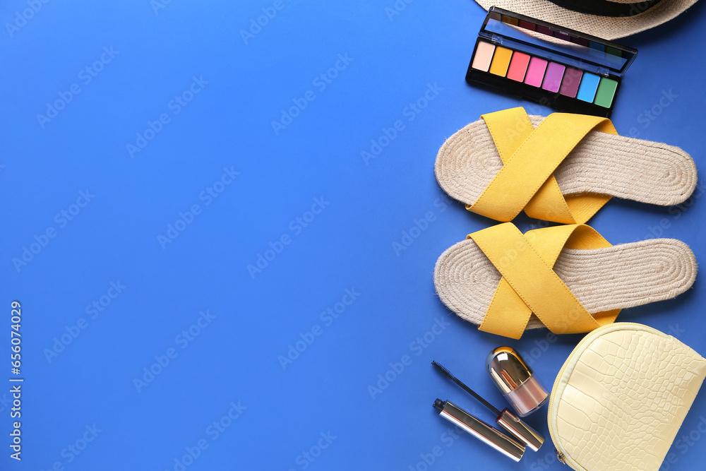 Composition with stylish female sandals and cosmetics on blue background