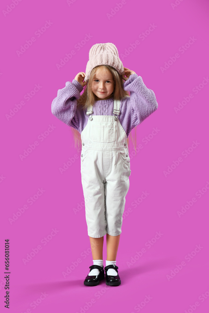 Cute little girl on purple background