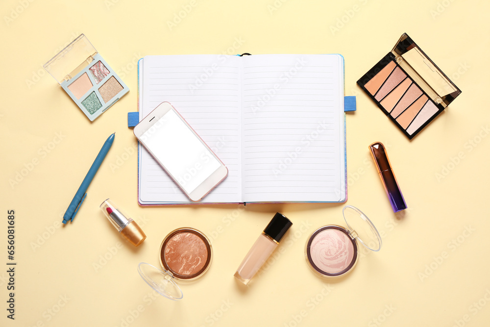 Composition with makeup cosmetics, modern mobile phone and notebook on beige background