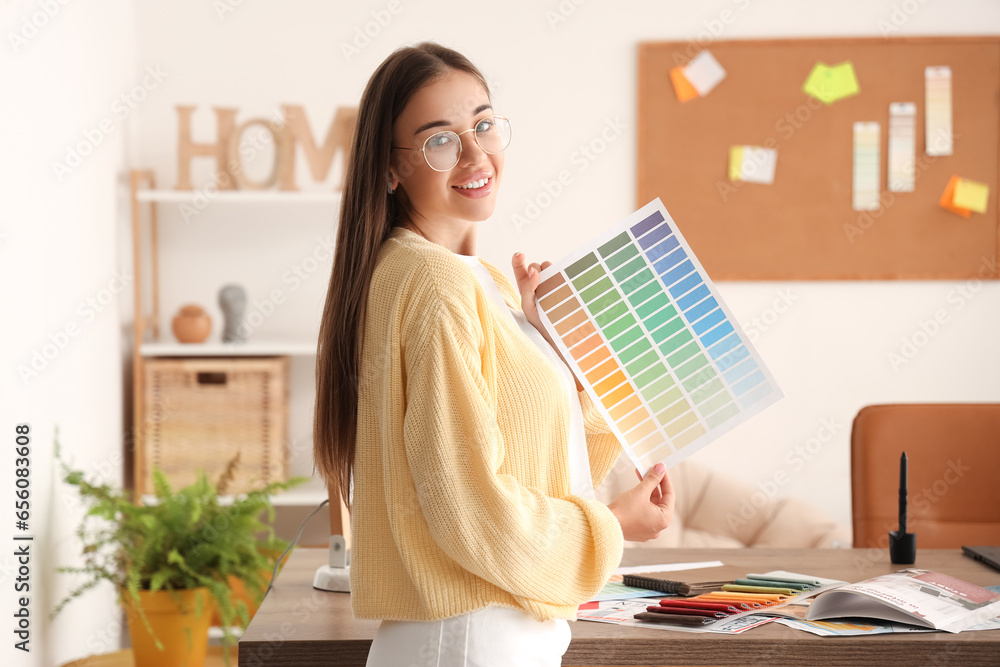 Female interior designer working with color palette in office