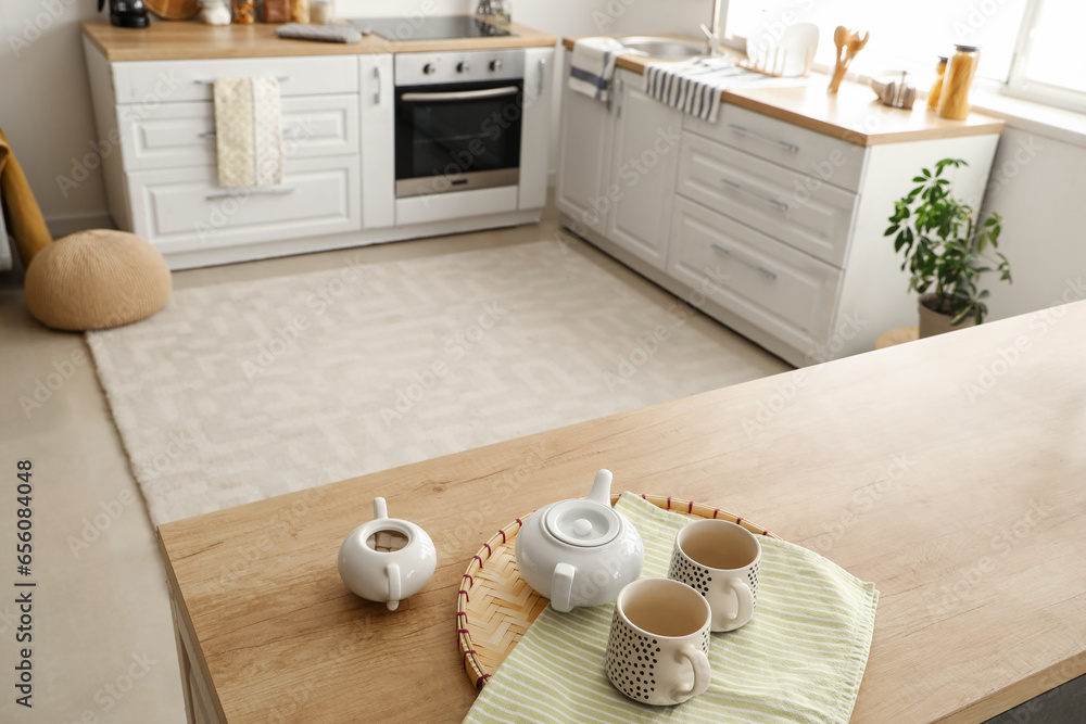 Tea set with sugar bowl on table in kitchen