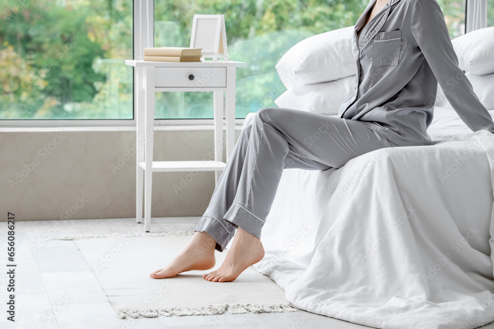 Barefoot woman with floor heating in bedroom