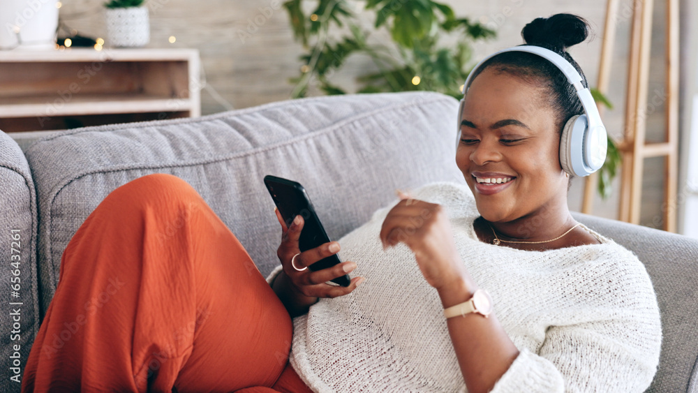 Black woman on couch, headphones for music and smartphone, relax at home and audio streaming with smile. Happiness, mobile app and using phone for radio or podcast, scroll with technology in lounge