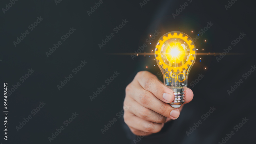 Hand holding illuminated light bulb, copyspace. Creative idea, new business plan, motivation, innovation, inspiration. Energy saving light bulb. Concept of new ideas with innovation and creativity.